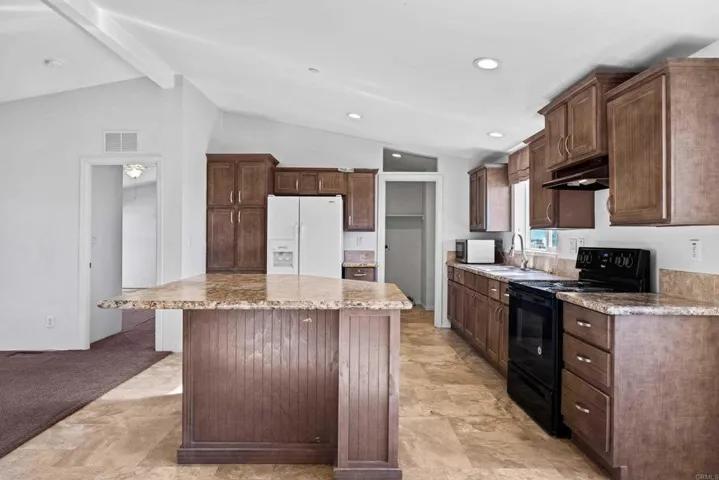 Laundry room can be seen from this view of the kitchen