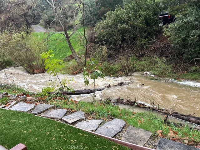 Creek during rain. Notice the tiered back yard.  Plenty of space for the creek to be high & enjoy the beauty.