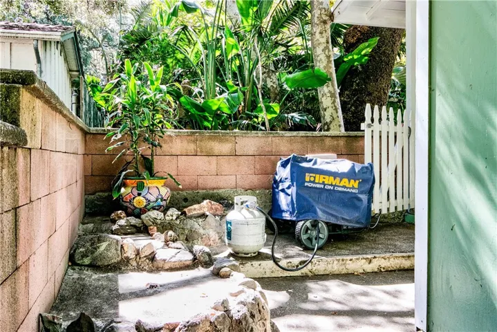 View looking from private entrance to 3rd bedroom towards private patio area & gate leading in.