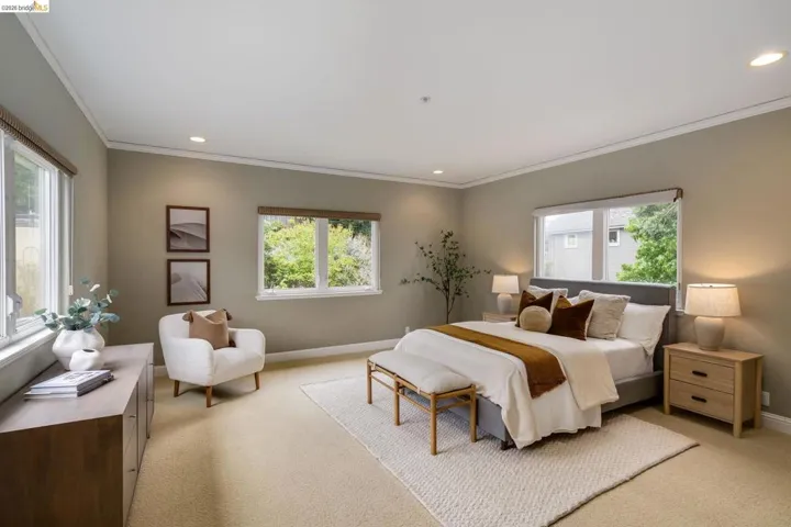 Bedroom with multiple windows, light carpet, crown molding, and recessed lighting