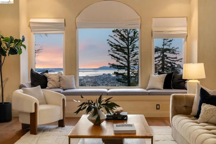 Living area with wood finished floors and a water view