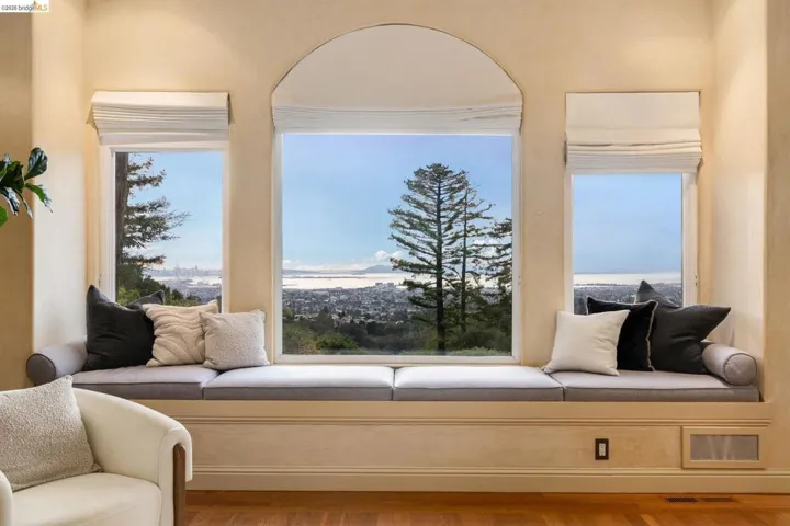 Sitting room with wood finished floors and a water view