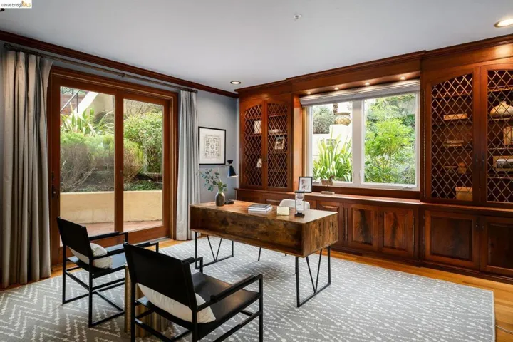 Office with light wood finished floors, crown molding, and recessed lighting