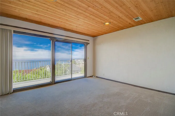 Bedroom #3 has a wall of glass windows and sliding glass doors leading out to the exterior balcony with outstanding ocean views. there is also a walk-in closet and recessed lights