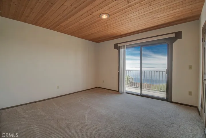 Bedroom #2, has ocean views, a walk-in closet and access to the outside deck with endless ocean views.