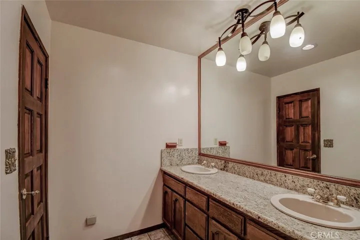 The 2nd bathroom on the lower level has 2 sinks and a shower/tub combo.