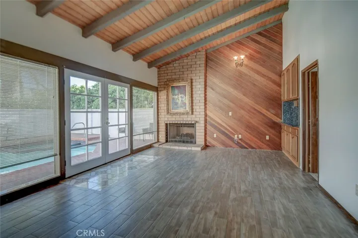 This is the family room off the kitchen and at the front of the home, where you can see the pool and spa.
