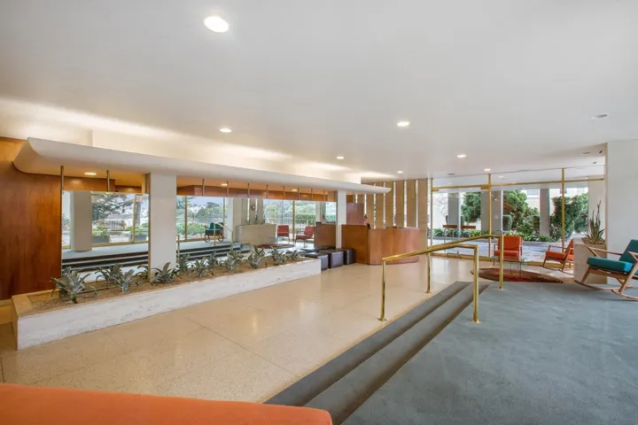 Living area featuring wooden walls and recessed lighting