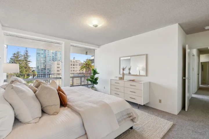 Carpeted bedroom with a textured ceiling and access to exterior