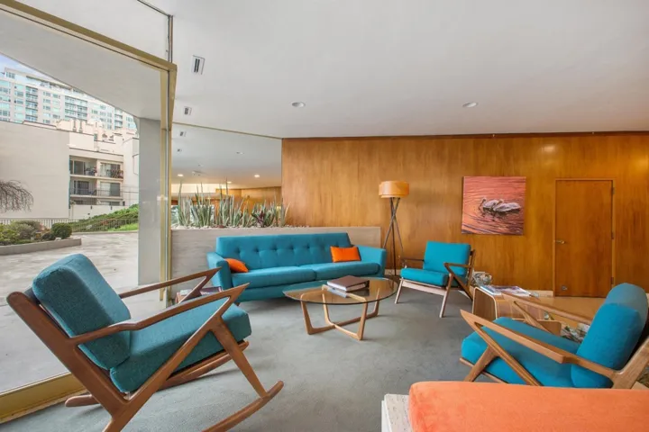 Living room with carpet, recessed lighting, and wooden walls