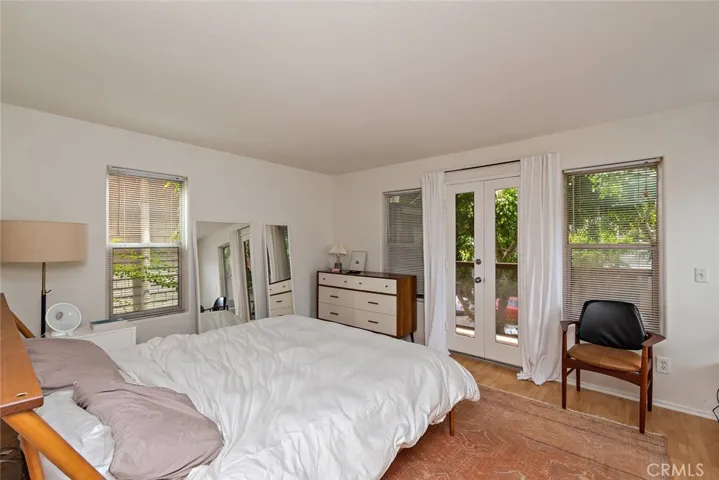 Primary bedroom with French doors to the front balcony.