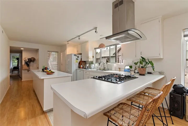 Open kitchen with island and bar seating.