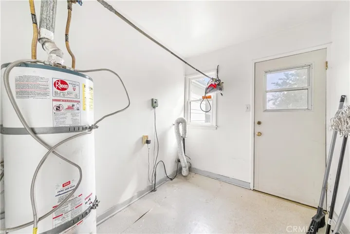 Laundry room which includes the water heater.