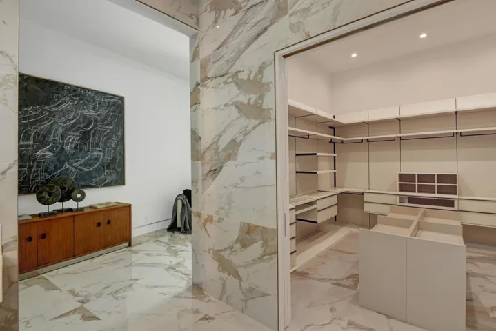 PRIMARY WALK IN CLOSET TO ENTRY HALL