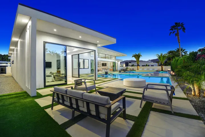 PRIMARY BEDROOM PATIO TO POOL NIGHT