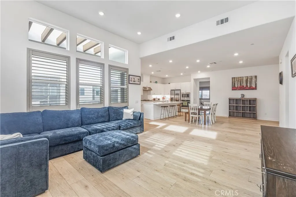 Spacious living room with lots of windows and added shutters