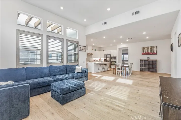 Spacious living room with lots of windows and added shutters