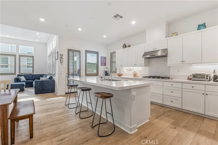Kitchen with oversized island and self closing drawers and cabinets