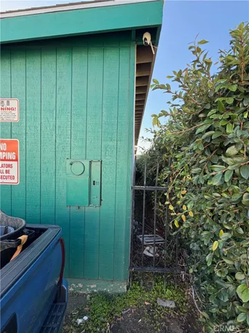 Rear view of storage unit 14, featuring a security camera, "No Dumping" signage, and gated access for added security.