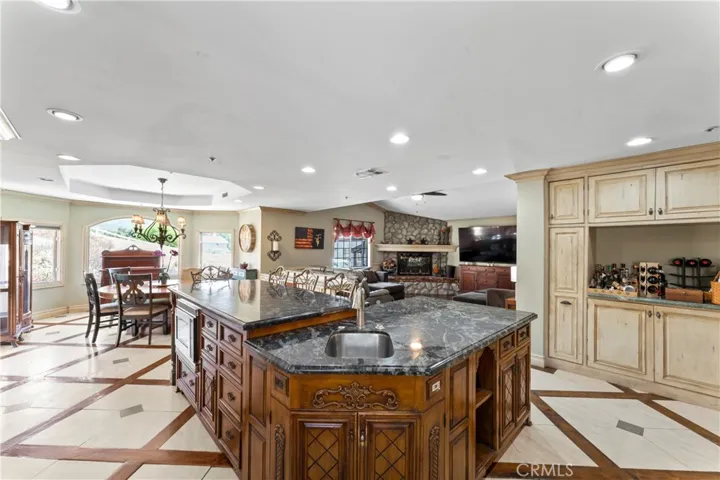 Kitchen Island looking into Family Room with Rock Fireplace