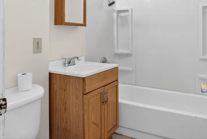 Full bath featuring vanity and shower / tub combination