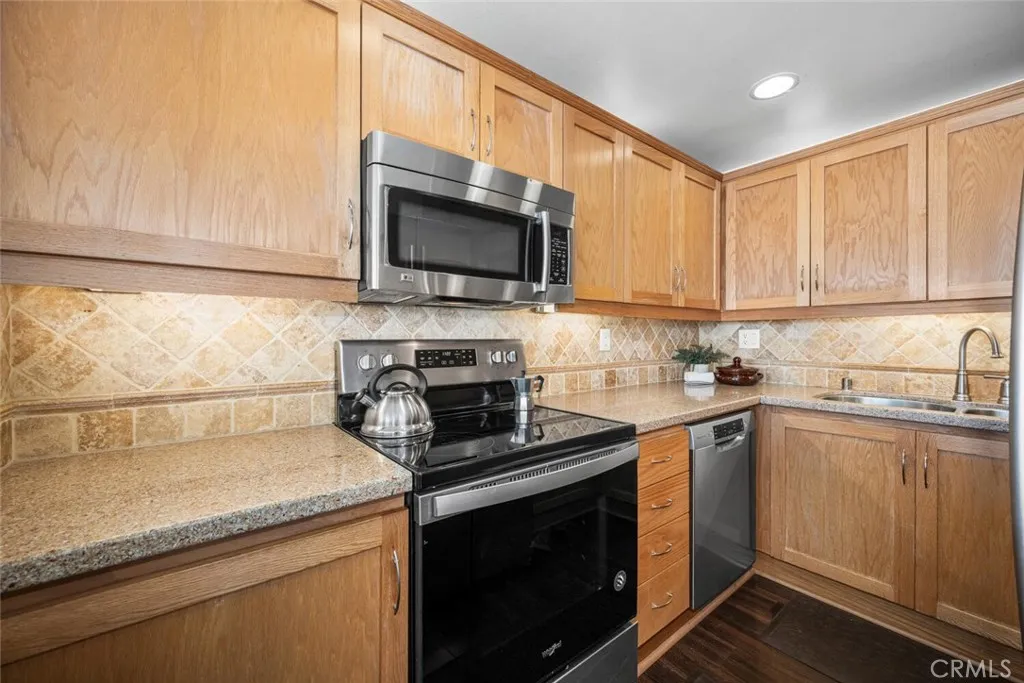 Updated kitchen with tile backsplash and recessed lighting.