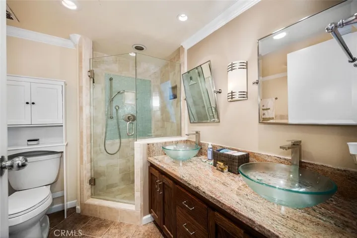 Dual vanities and a separate walk-in shower in the master bath.