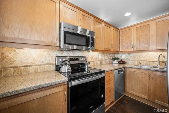 Updated kitchen with tile backsplash and recessed lighting.