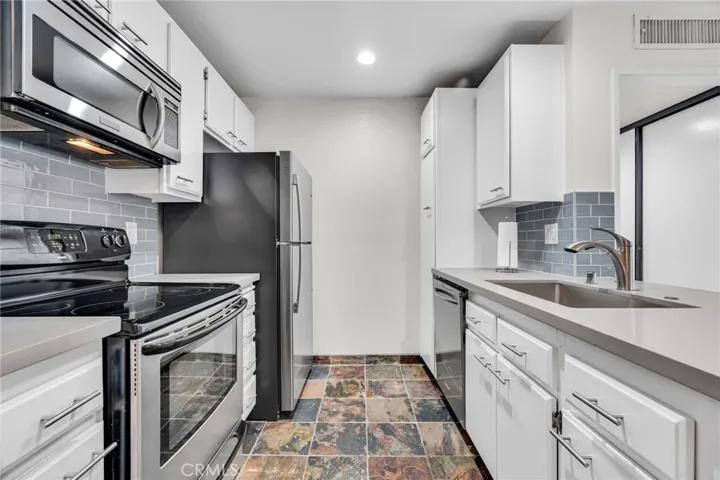 Modern kitchen with updated lighting and counters