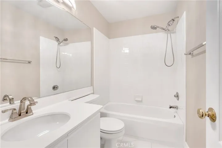 The upstairs guest bathroom has an upgraded countertop, faucet hardware and light fixture.