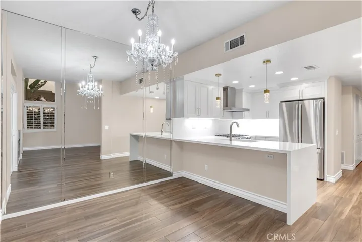 Another view of the dining room as well as the kitchen.