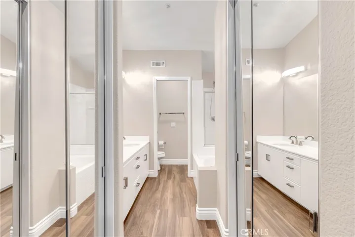 The primary bathroom has dual mirrored closets.