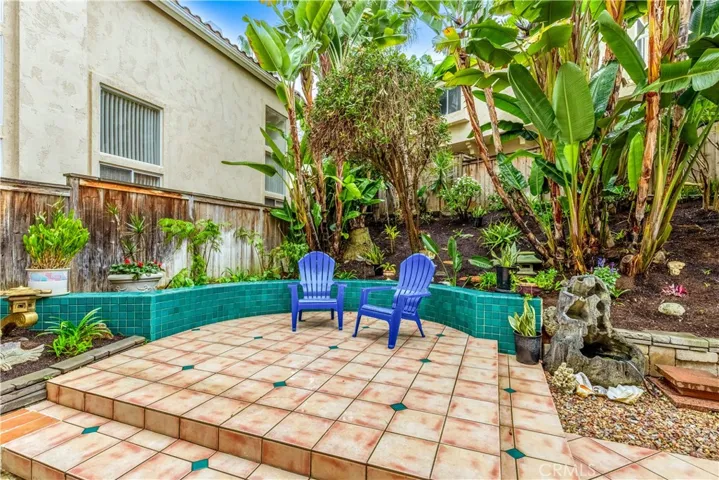 The large backyard has fresh landscaping throughout.