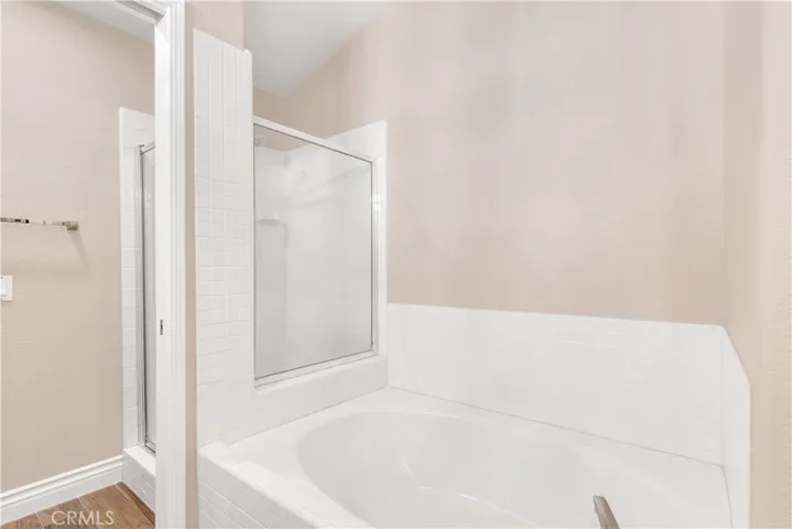 The primary bathroom has a soaking tub as well as a walk in shower.