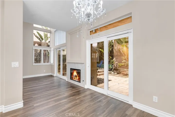 The dining room has a sliding glass door as well as a chandelier.