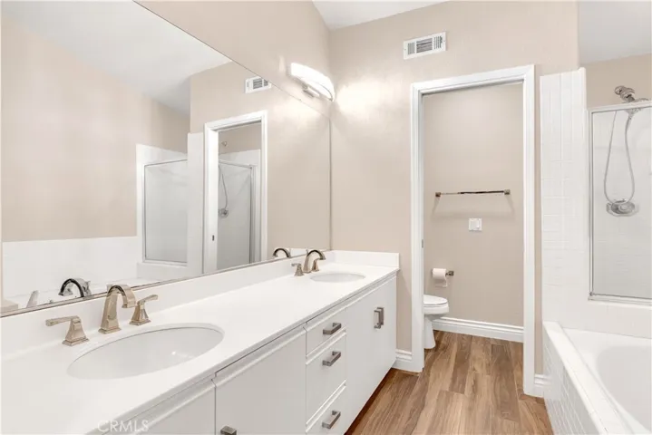The primary bathroom has a walk in shower, a soaking tub as well as a dual vanity setup with upgrades.