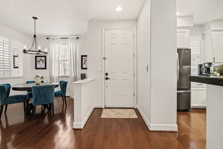 Entryway featuring dark wood-type flooring, a chandelier, and recessed lighting