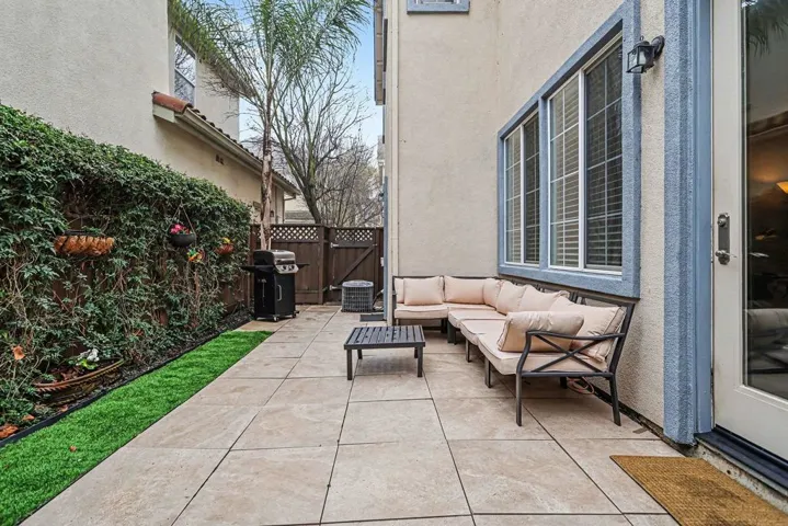 View of patio with outdoor lounge area and grilling area