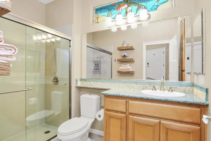Full bathroom with a shower stall and vanity