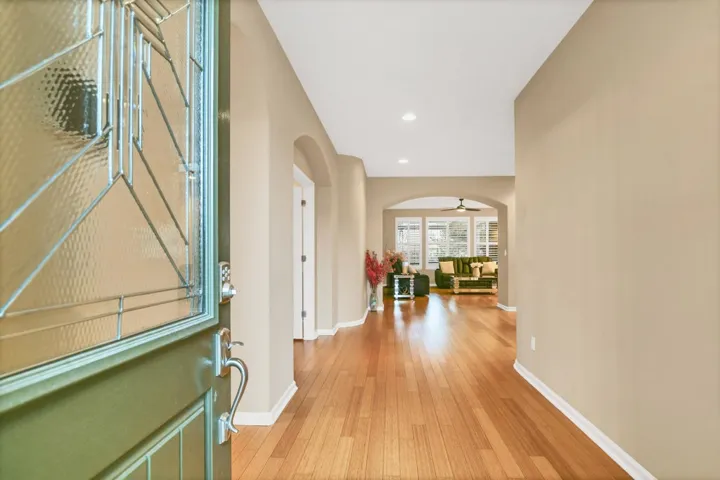 Foyer entrance featuring arched walkways, light wood-style flooring, recessed lighting, and a ceiling fan