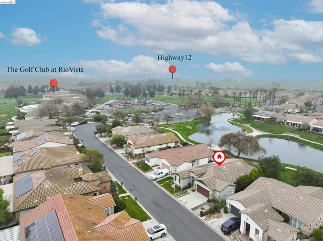 Aerial perspective of suburban area with a large body of water