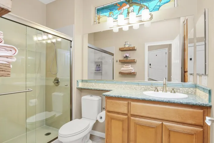 Full bathroom with a shower stall and vanity
