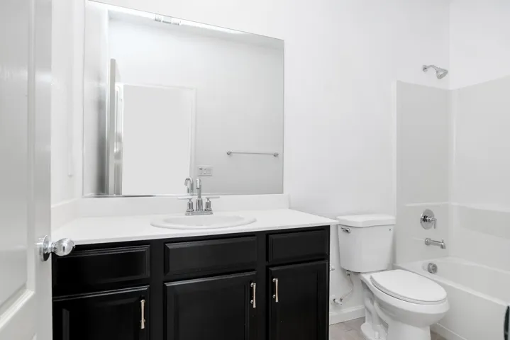 Bathroom with vanity and shower / tub combination