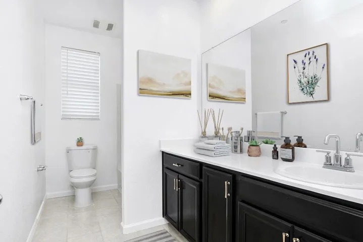 Full bath featuring vanity and light tile patterned floors