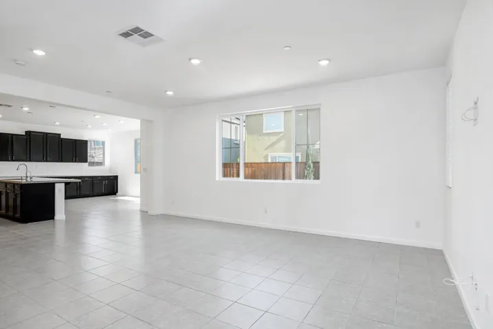 Unfurnished living room featuring plenty of natural light, recessed lighting, and light tile patterned floors