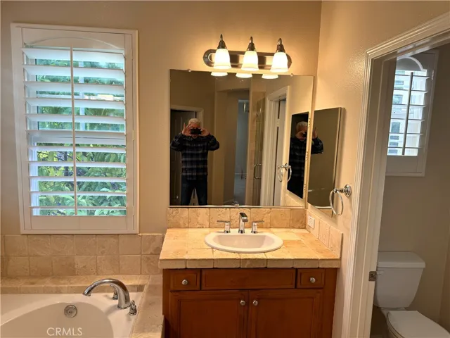Primary Bath Vanity #1.  Plantation Shutters.  Tumbled Marble Counters.