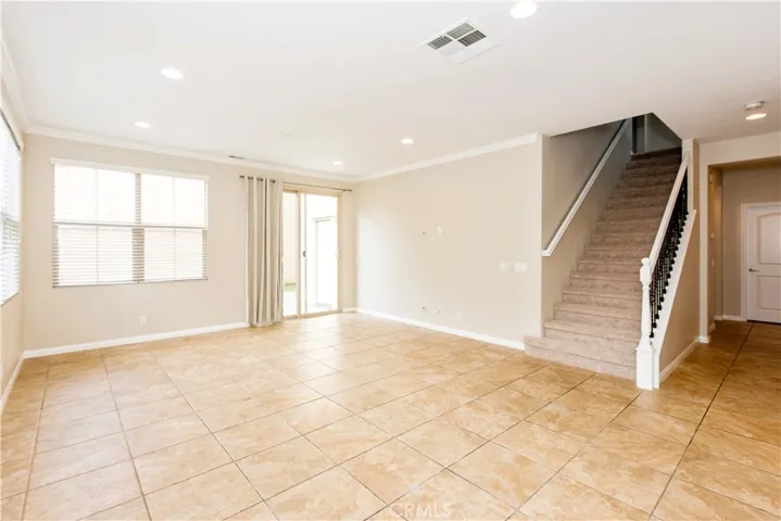 The light-filled great room includes a cozy fireplace and sliding glass doors open to the private backyard