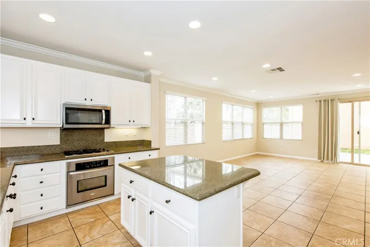 The gourmet kitchen showcases center island with a breakfast bar