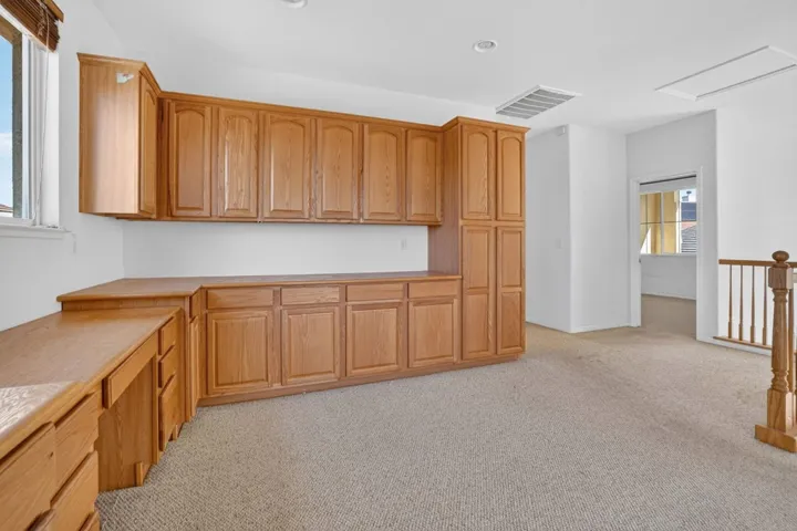 Kitchen with light countertops and light colored carpet