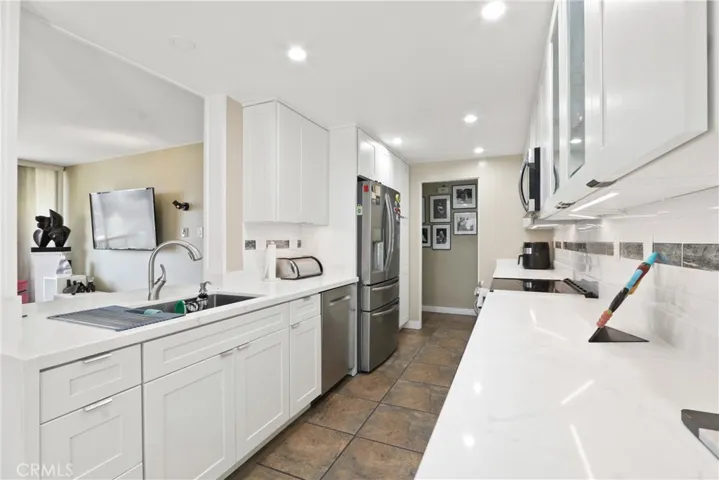 Upgraded kitchen layout highlighting extensive counter space and modern stainless steel appliances.
